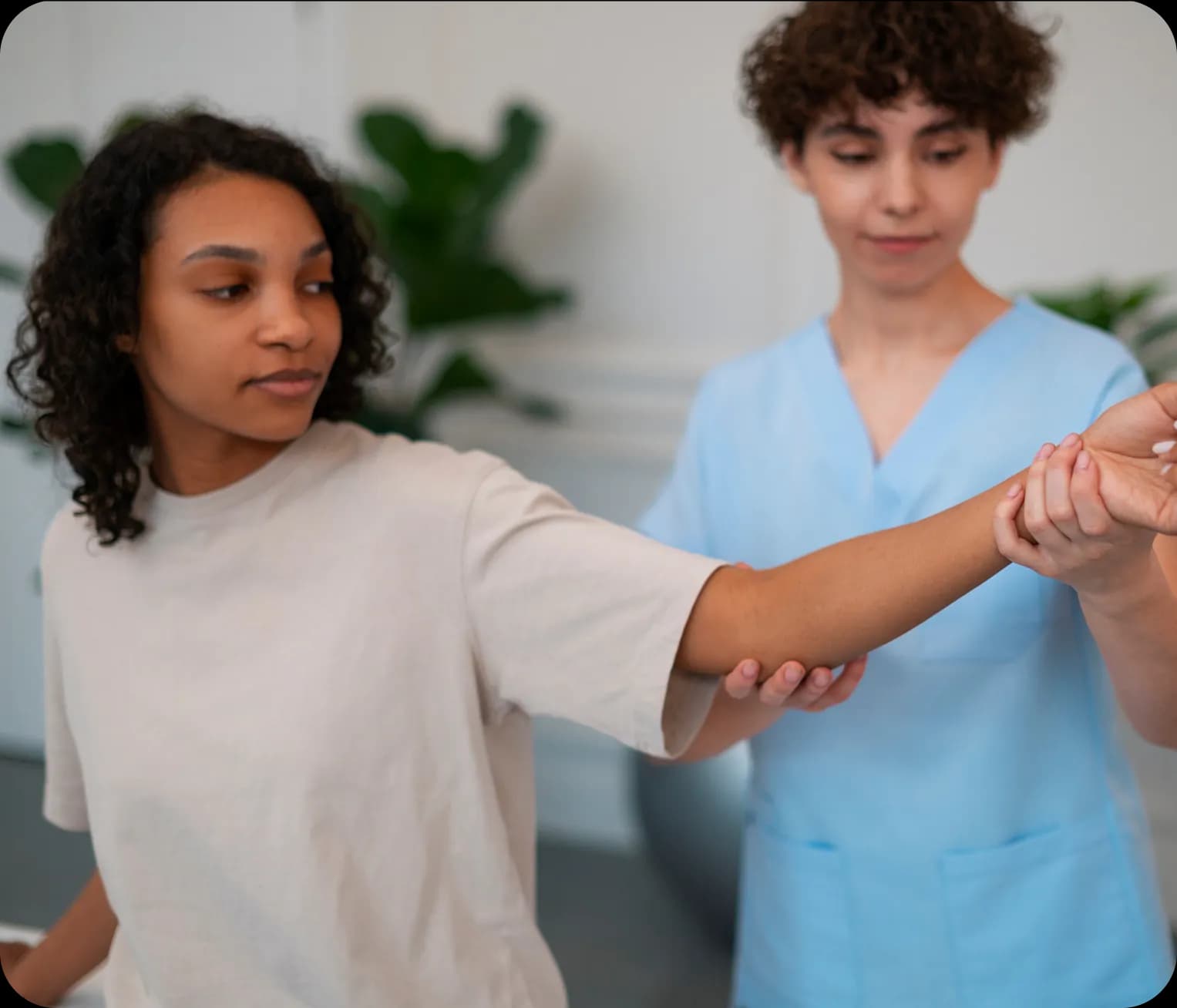 Physiotherapist assessing patient arm mobility